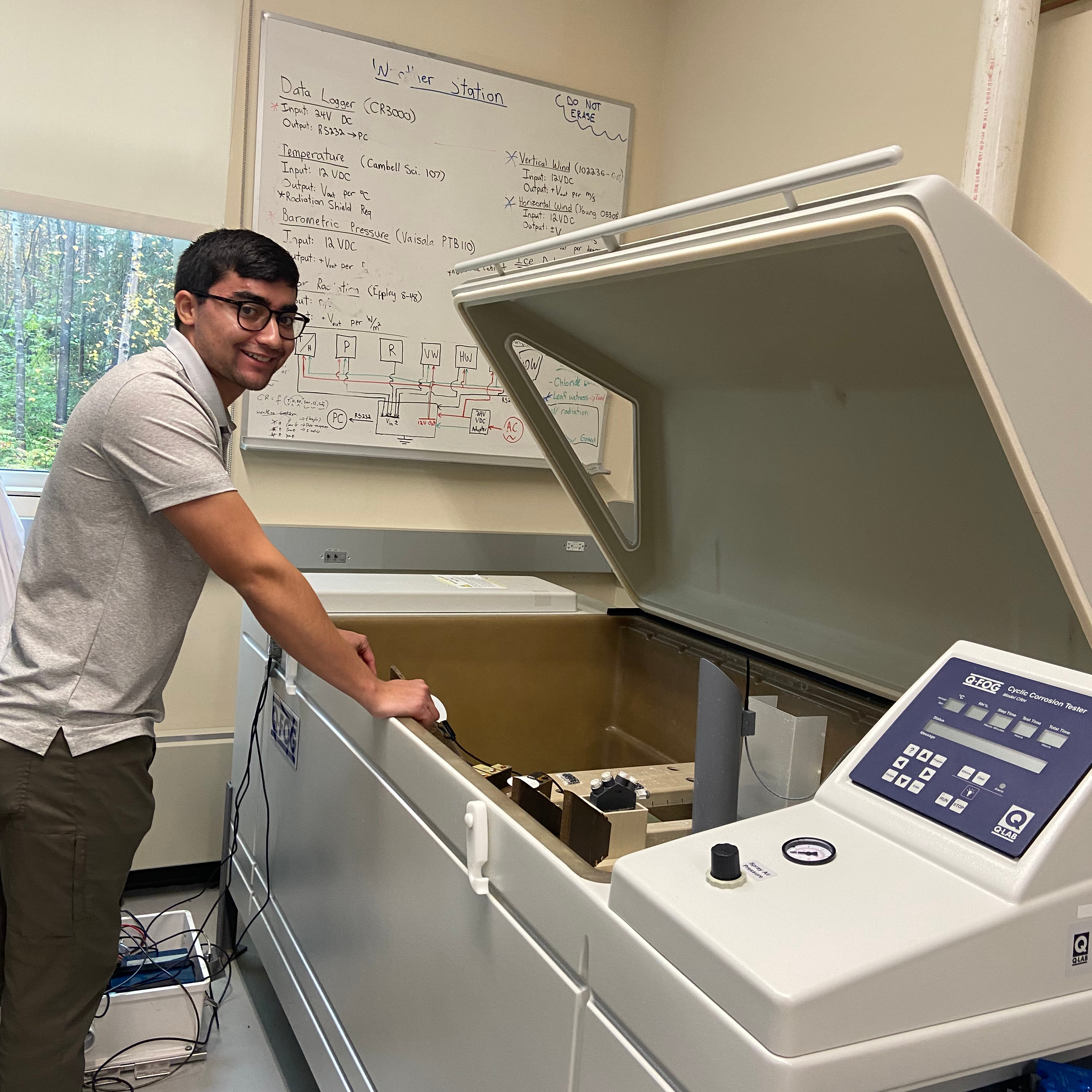 Benjamin Almeida using the Cyclic Corrosion Tester at the Environmental Degradation Lab