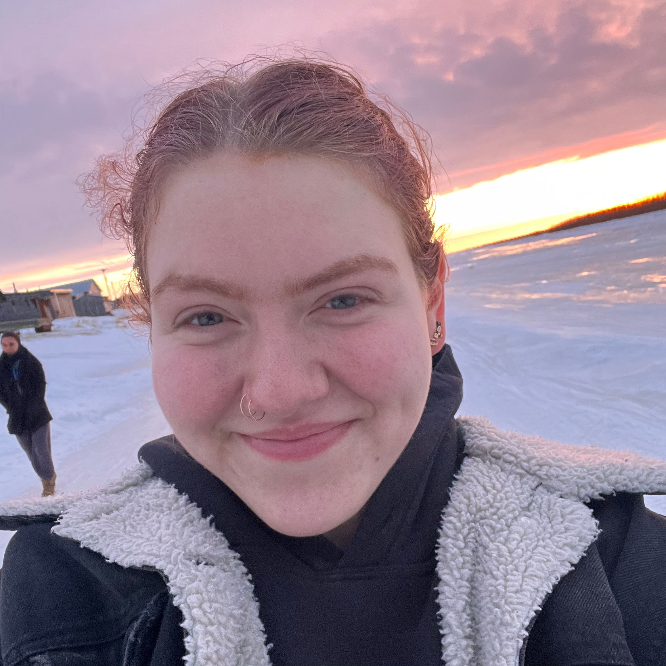 Elisa Burnett posing next to the Kuskowim River at Sunset.