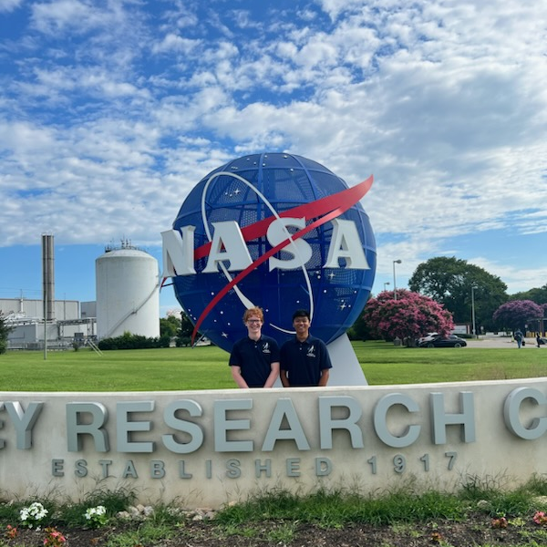Photo of Seth (Left) and friend in front of NASA meatball.